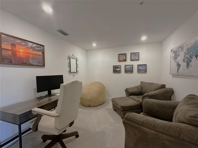 a work room with furniture and a flat screen tv