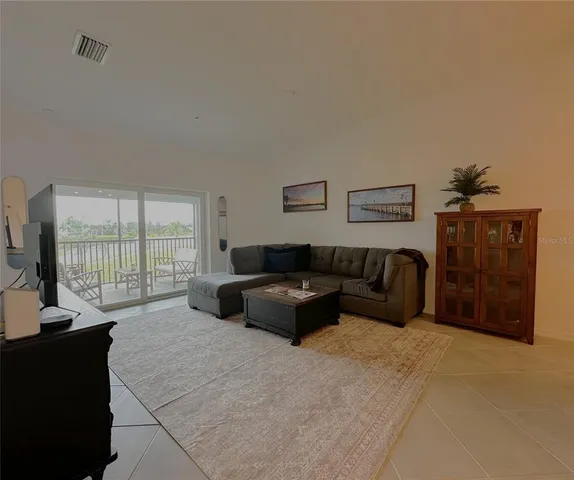 a spacious bedroom with a bed and glass window