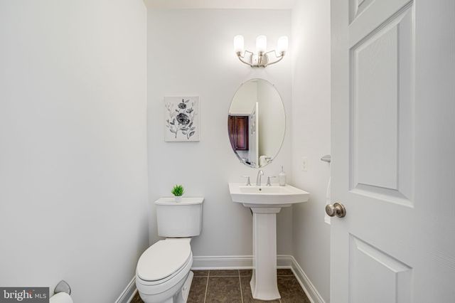 a kitchen with stainless steel appliances granite countertop a sink a stove a refrigerator a counter top space and living room view