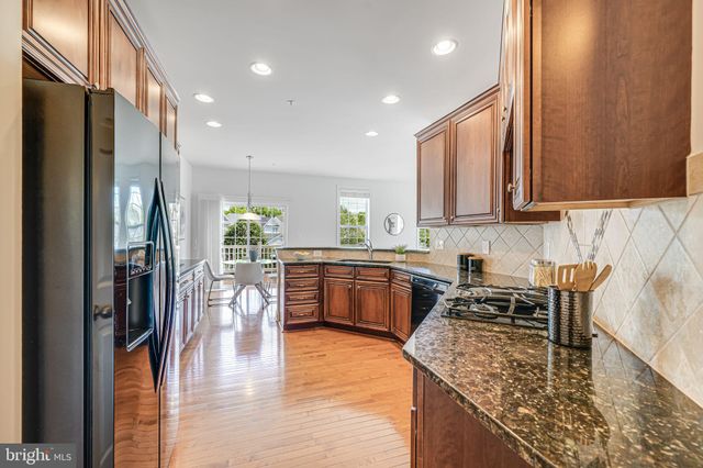 a view of a kitchen with kitchen island a large window in it