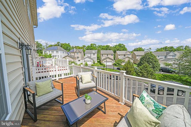 a living room with furniture kitchen view and a window
