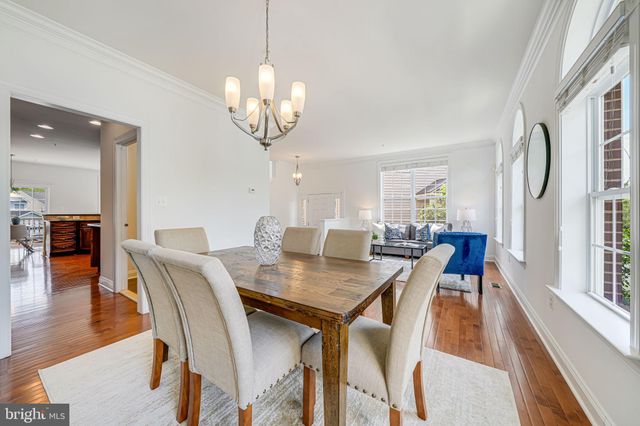 a view of a dining room with furniture wooden floor and chandelier