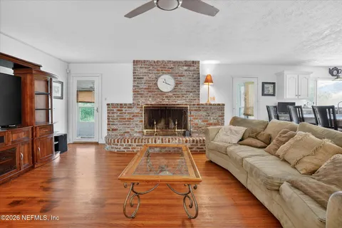 a living room with furniture and wooden floor