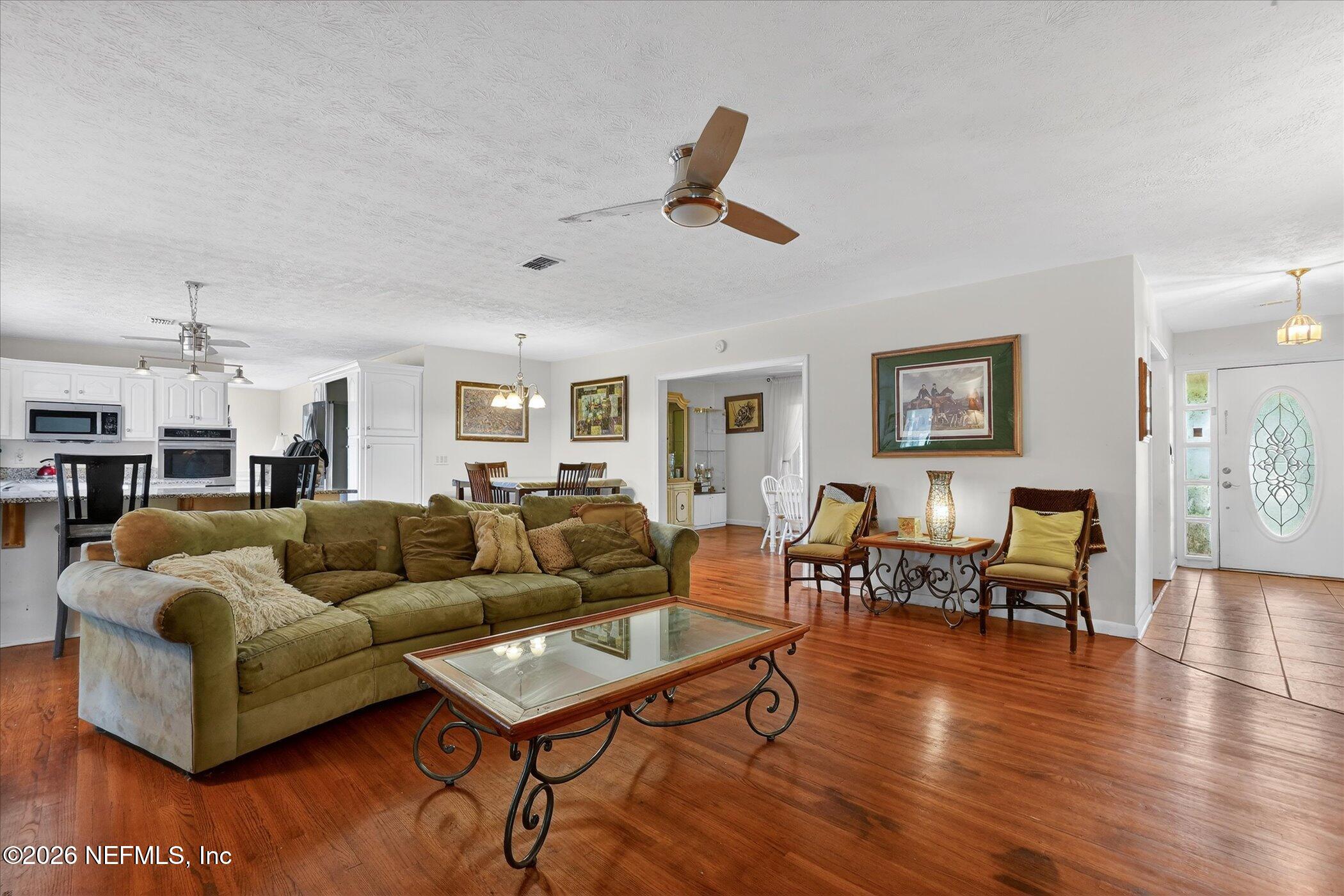 4242 Hillwood Road Jacksonville, FL 32223 - Photo 22 of 36 a living room with furniture and wooden floor