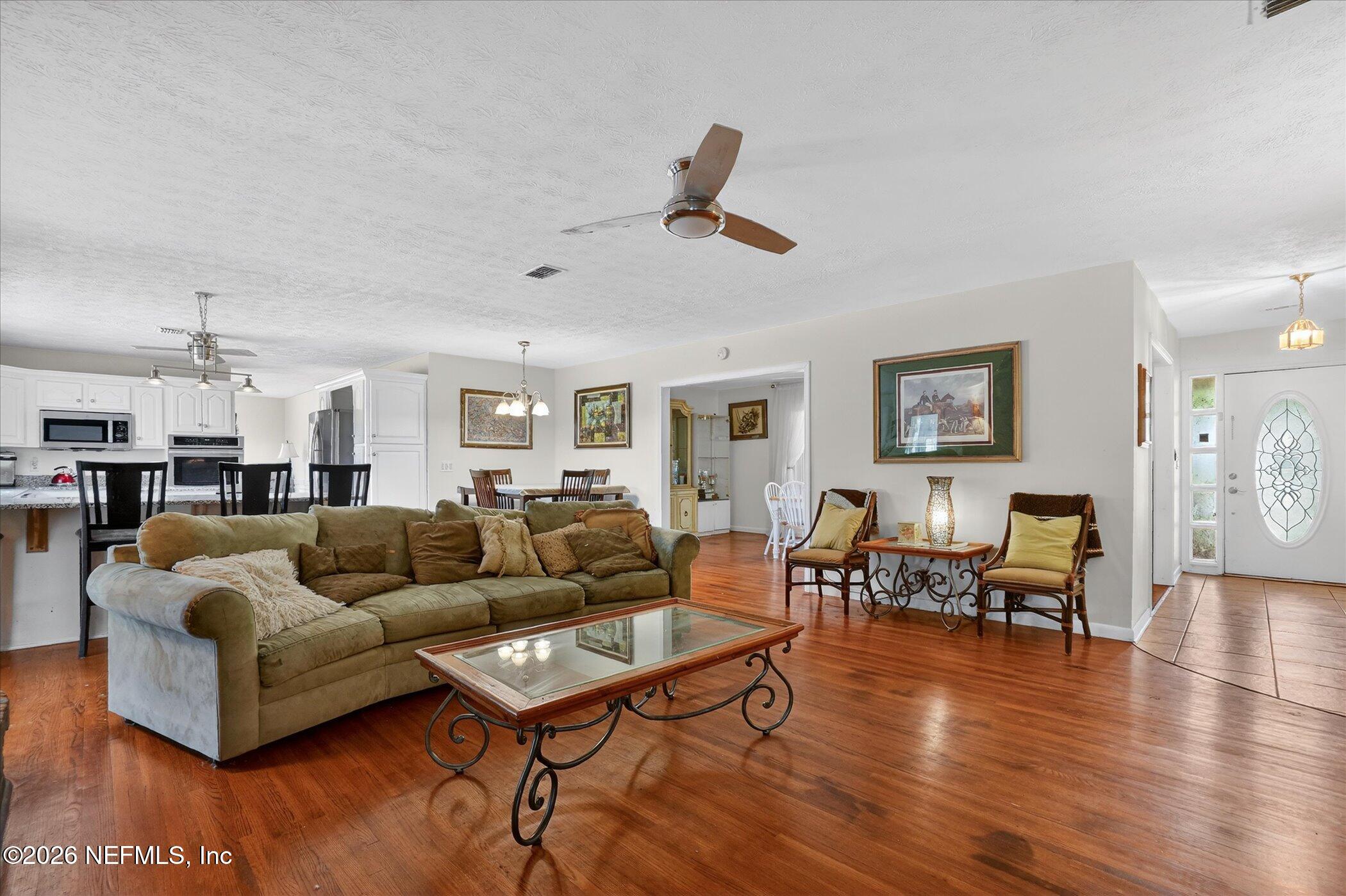 4242 Hillwood Road Jacksonville, FL 32223 - Photo 24 of 36 a living room with furniture and wooden floor