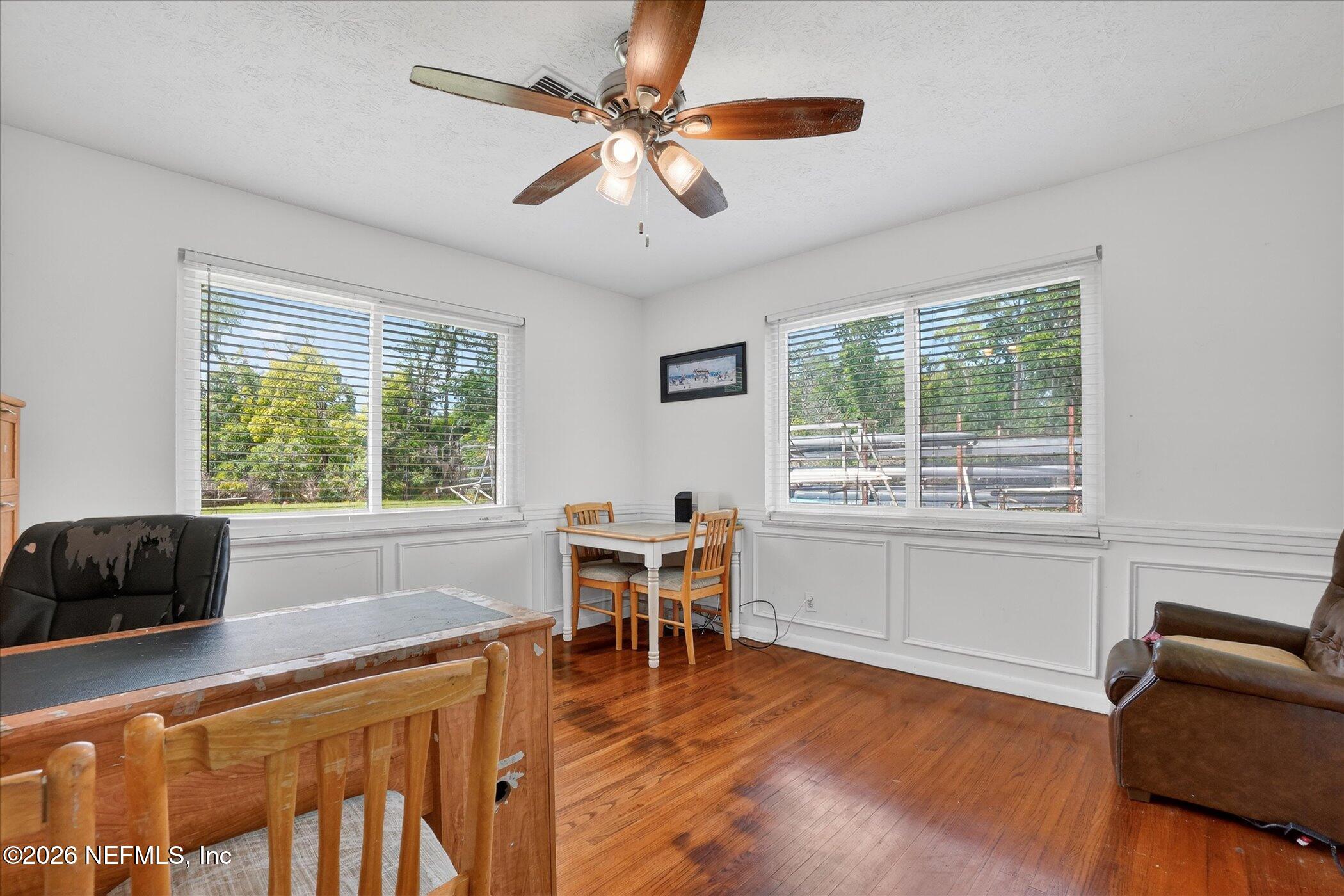 4242 Hillwood Road Jacksonville, FL 32223 - Photo 28 of 36 a dining room with wooden floor and a window