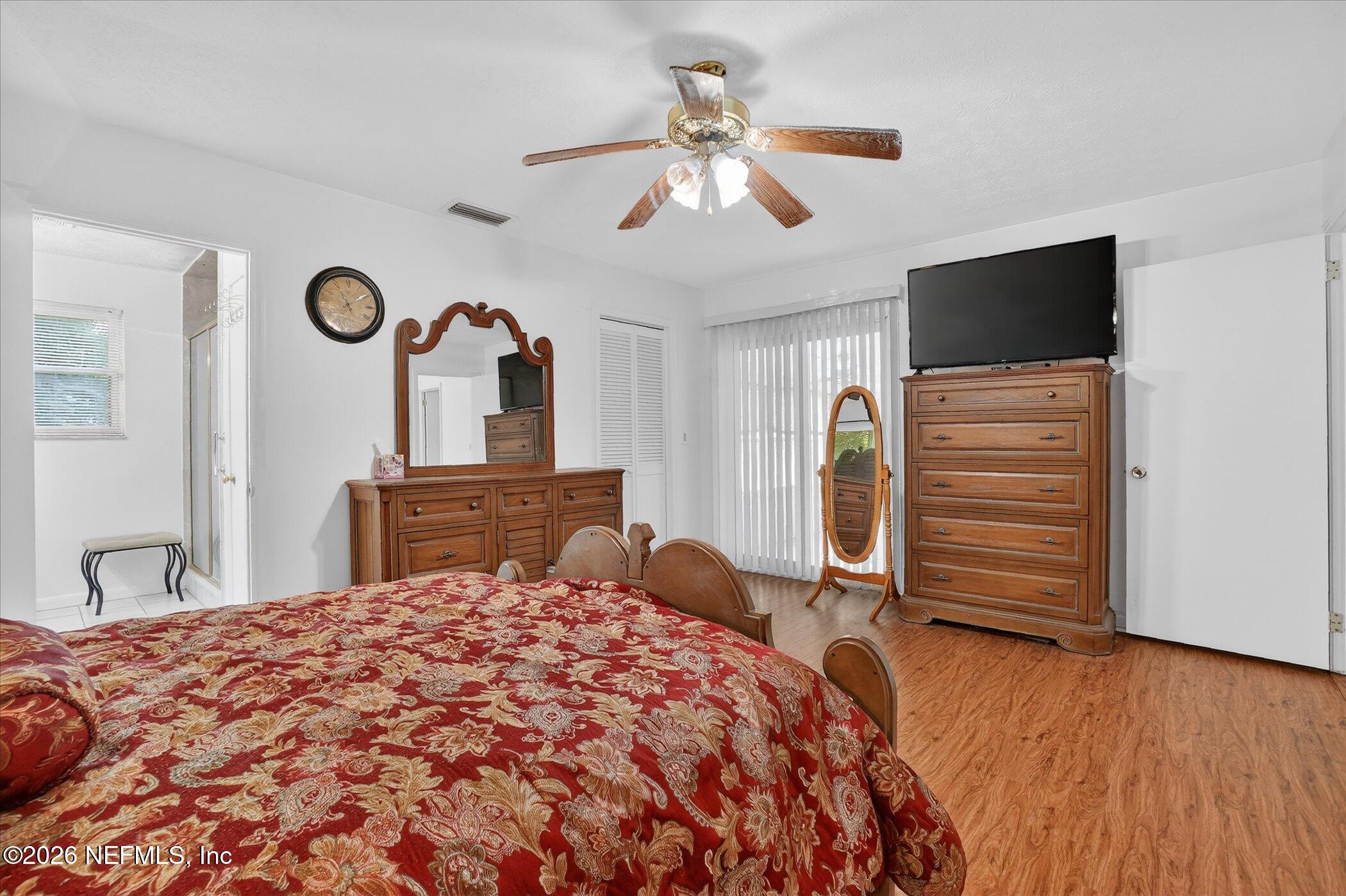 4242 Hillwood Road Jacksonville, FL 32223 - Photo 30 of 36 a bedroom with a bed and a flat tv screen on dresser