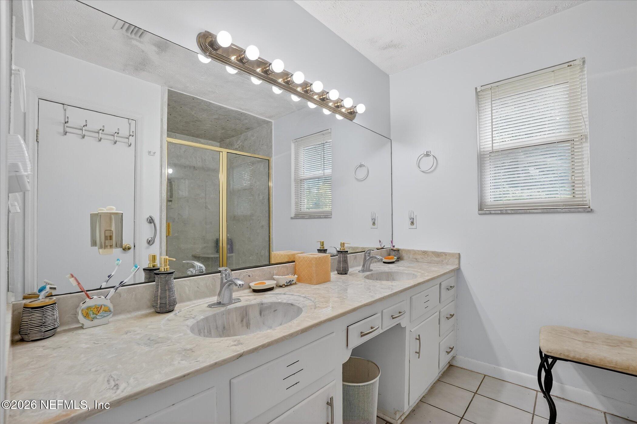 4242 Hillwood Road Jacksonville, FL 32223 - Photo 31 of 36 a bathroom with a sink double vanity and a mirror