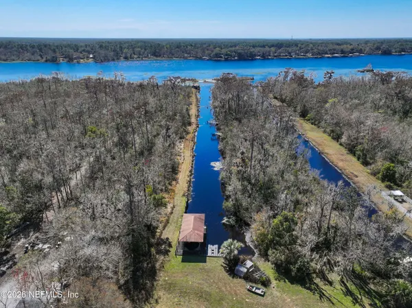 a aerial view of a house with a garden and lake view