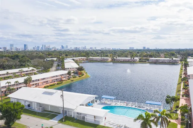 aerial view of a house with outdoor space and lake view in back