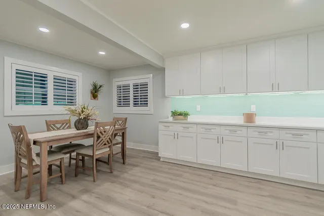 a view of a dining room with furniture and window