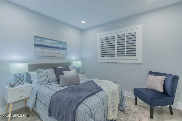 a bedroom with a bed and a chair