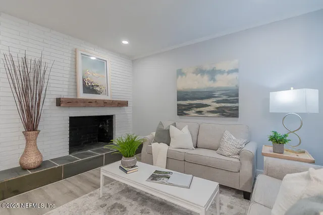 a living room with furniture and a fireplace