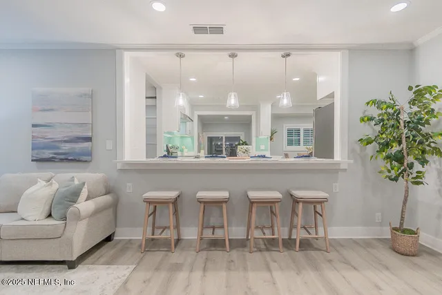 a living room with furniture and a potted plant