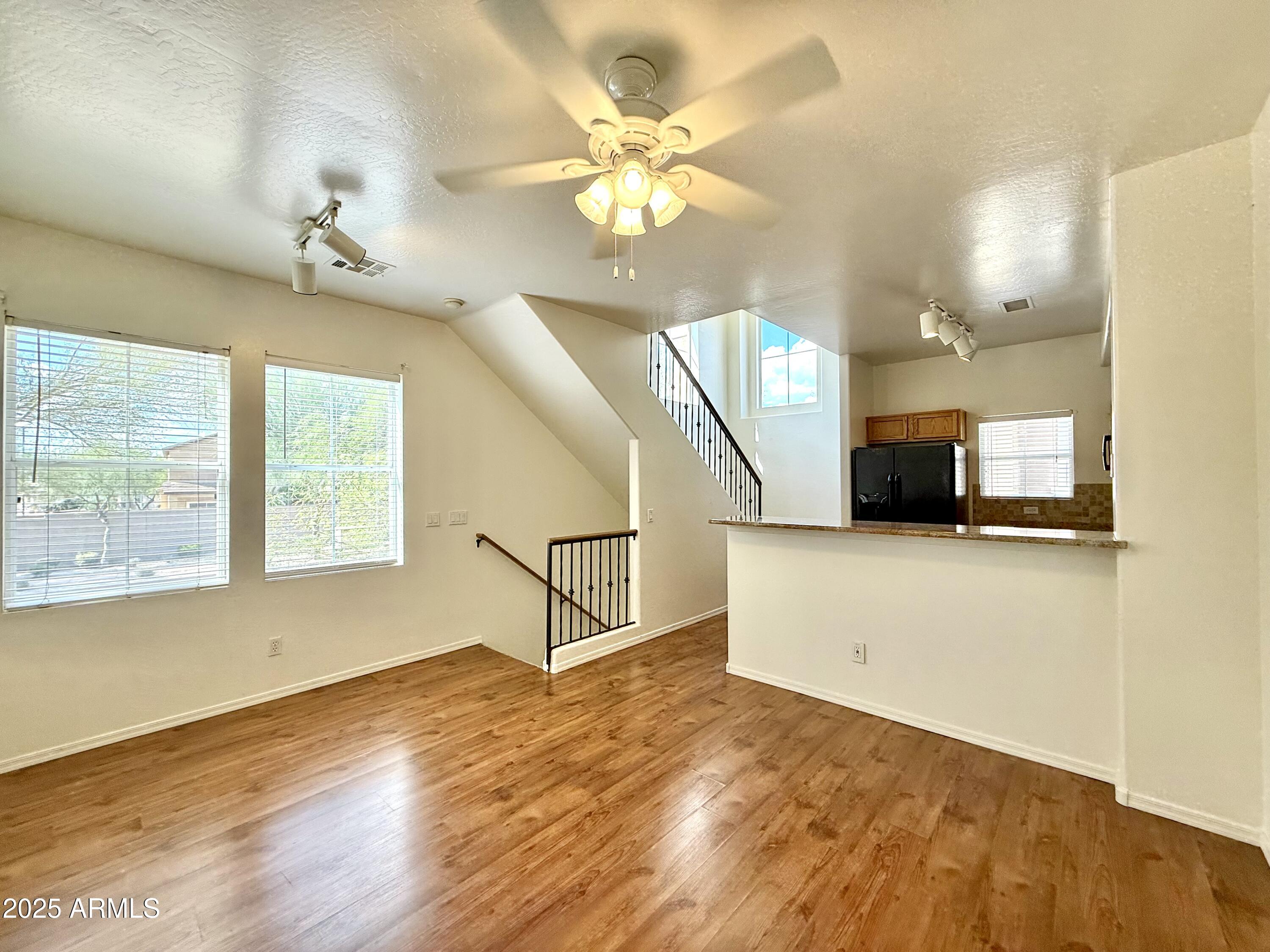 34924 North 30th Avenue Phoenix, AZ 85086 - Photo 7 of 20 a view of an empty room with a window and wooden floor