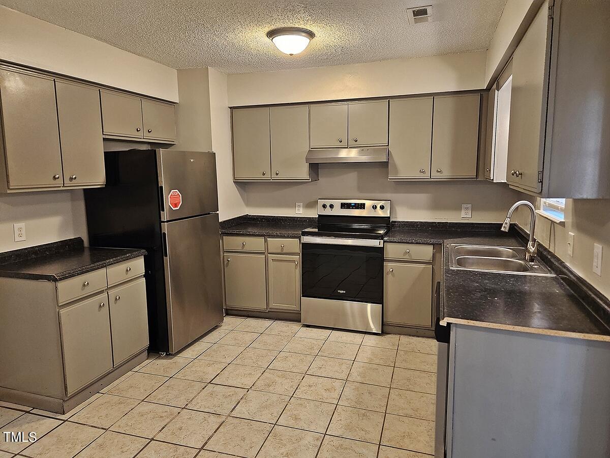 11 Howlett Place Durham, NC 27703 - Photo 13 of 27 a kitchen with a sink appliances and cabinets