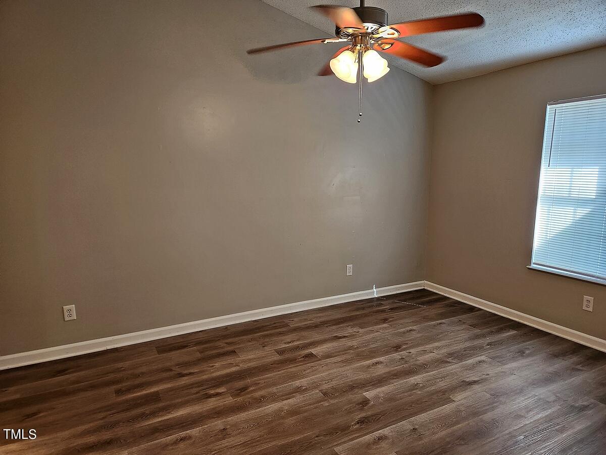 11 Howlett Place Durham, NC 27703 - Photo 15 of 27 a view of an empty room with wooden floor and a window