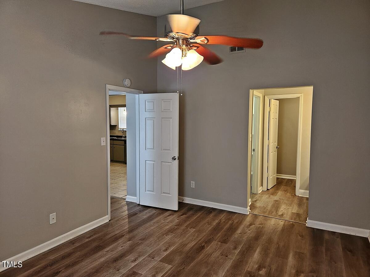 11 Howlett Place Durham, NC 27703 - Photo 16 of 27 a view of an empty room with a window and wooden floor