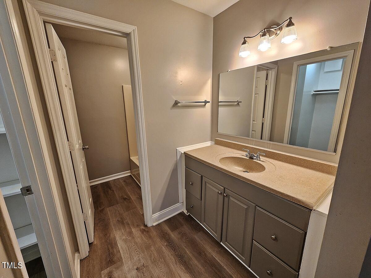 11 Howlett Place Durham, NC 27703 - Photo 18 of 27 a bathroom with a double vanity sink a mirror and a shower