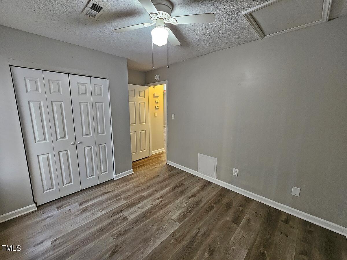 11 Howlett Place Durham, NC 27703 - Photo 22 of 27 an empty room with wooden floor fan and windows