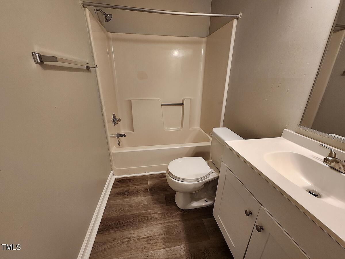 11 Howlett Place Durham, NC 27703 - Photo 24 of 27 a bathroom with a toilet a sink and shower