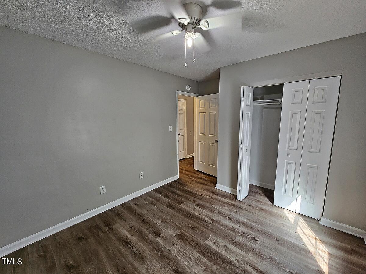 11 Howlett Place Durham, NC 27703 - Photo 26 of 27 an empty room with wooden floor and entryway