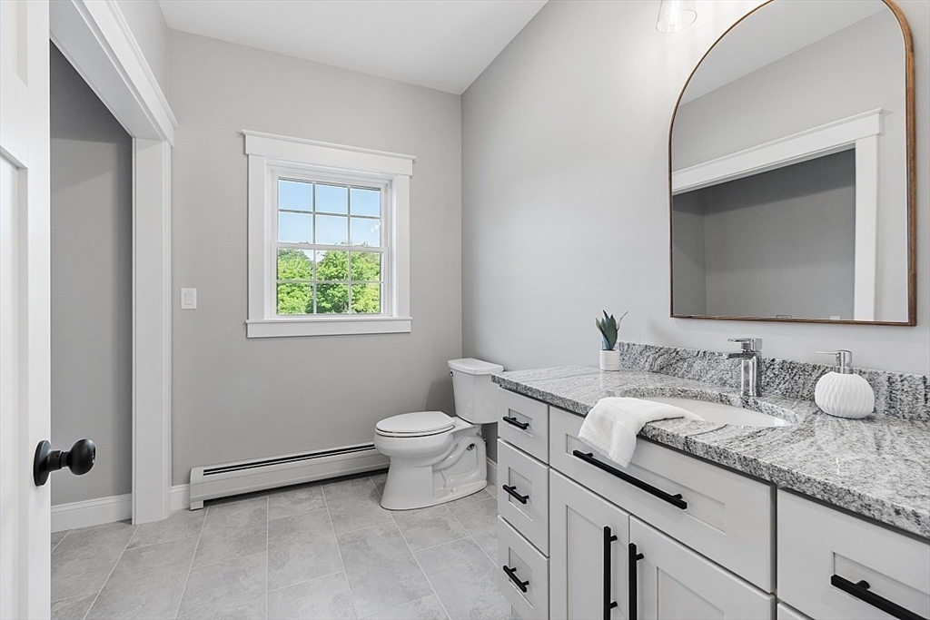 1371 South Athol Road Athol, MA 01331 - Photo 19 of 39 a bathroom with a granite countertop toilet sink and mirror