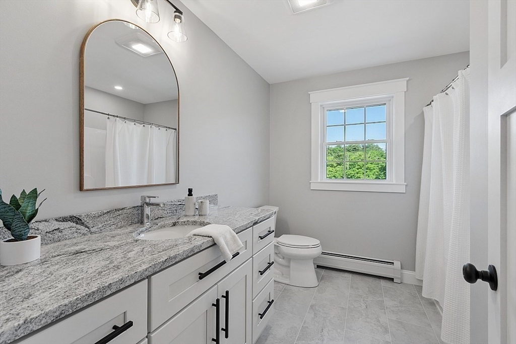 1371 South Athol Road Athol, MA 01331 - Photo 29 of 39 a bathroom with a granite countertop toilet sink and mirror