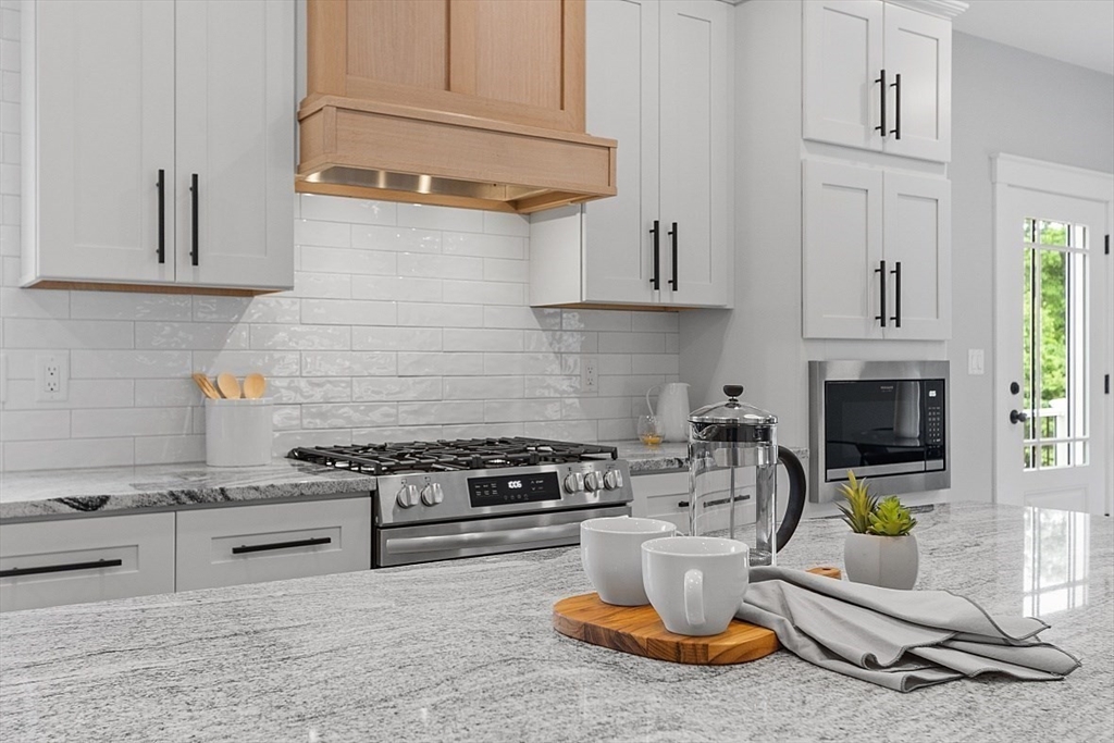 1371 South Athol Road Athol, MA 01331 - Photo 8 of 39 a kitchen with a stove and white cabinets