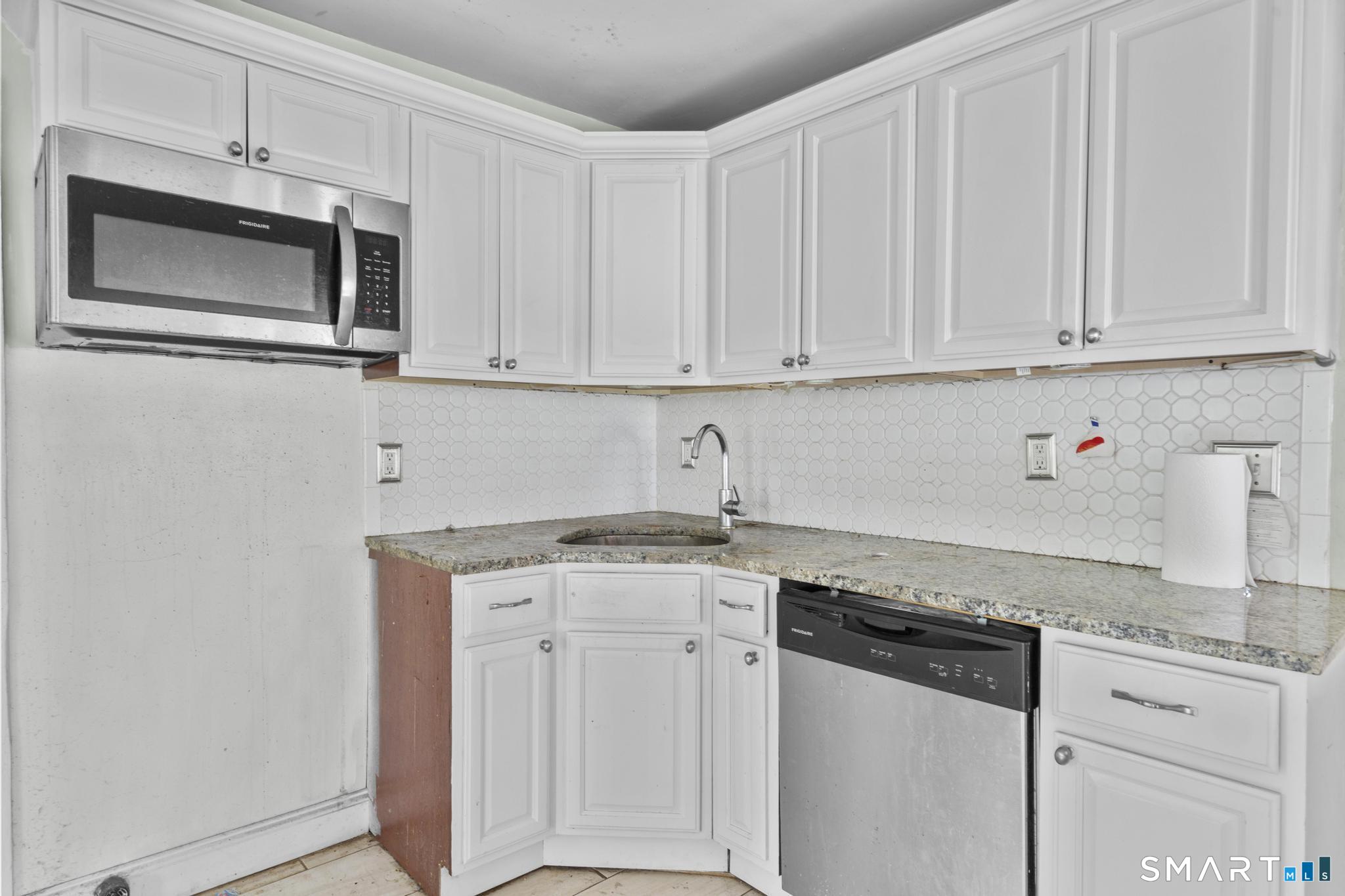 101 Meridian Street Meriden, CT 06451 - Photo 8 of 26 a kitchen with granite countertop white cabinets and white appliances