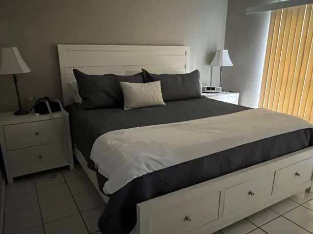 a bedroom with a bed and window