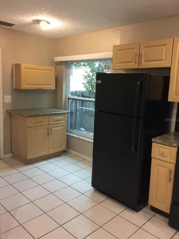 a kitchen with a refrigerator and a stove
