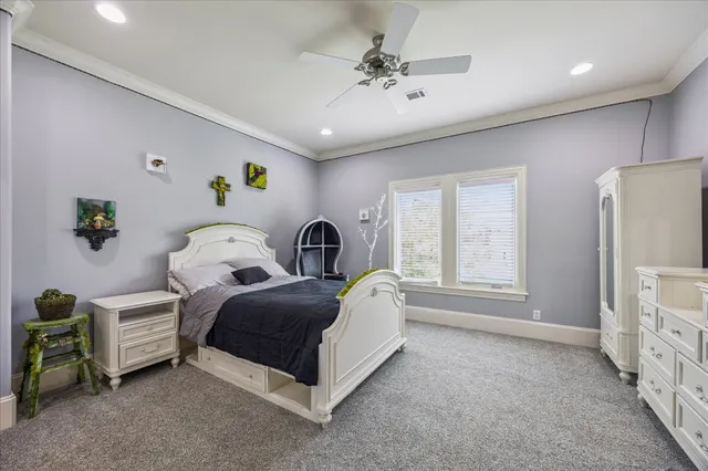 a spacious bedroom with a bed dresser and a window