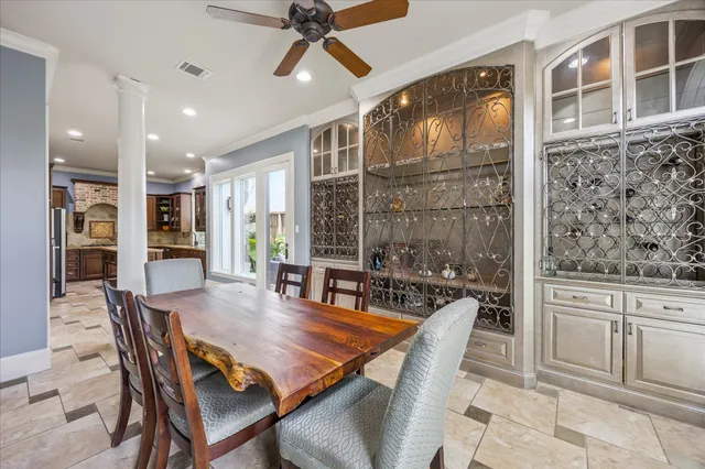a dining room with furniture a floor to ceiling window and wooden floor