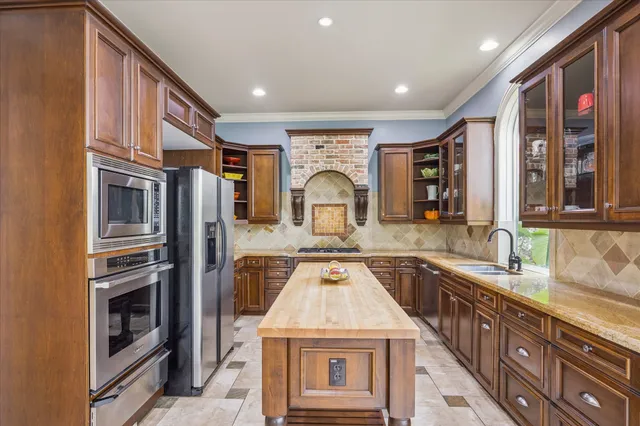 a kitchen with stainless steel appliances granite countertop a stove and a sink