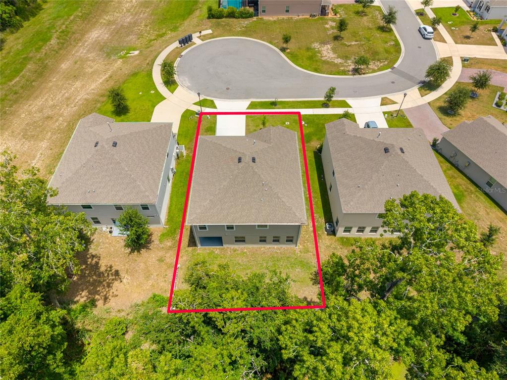 1137 Bradford Rdg Drive Leesburg, FL 34748 - Photo 33 of 37 an aerial view of a house with a swimming pool and garden