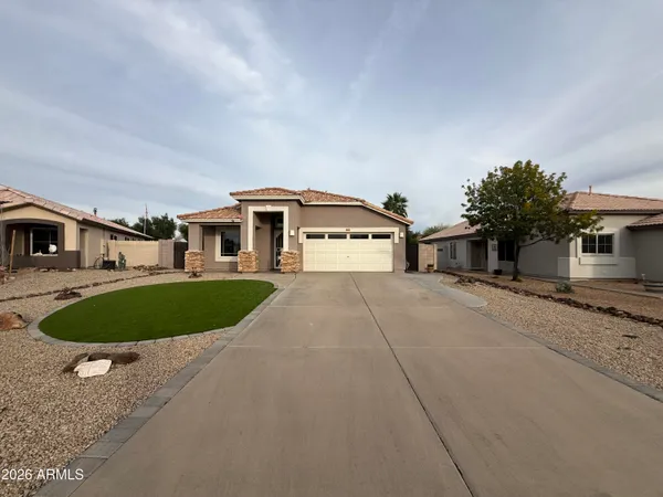 a front view of a house with a yard and trees