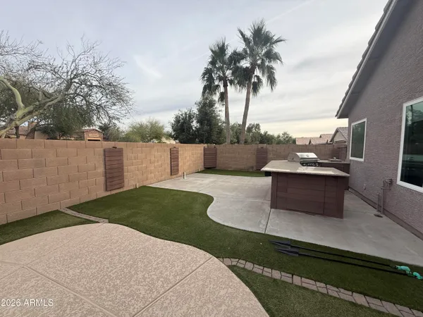 a view of a terrace with couches and wooden fence