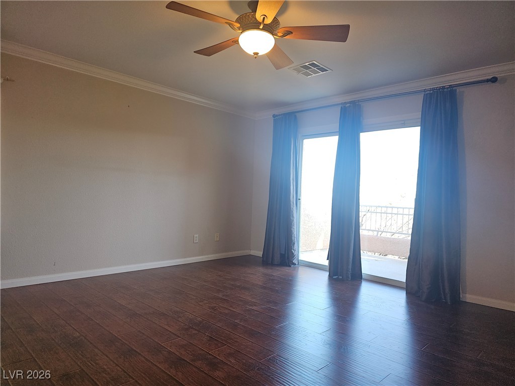 11081 Village Ridge Lane Las Vegas, NV 89135 - Photo 11 of 18 Spare room featuring ornamental molding, dark wood-style floors, and ceiling fan
