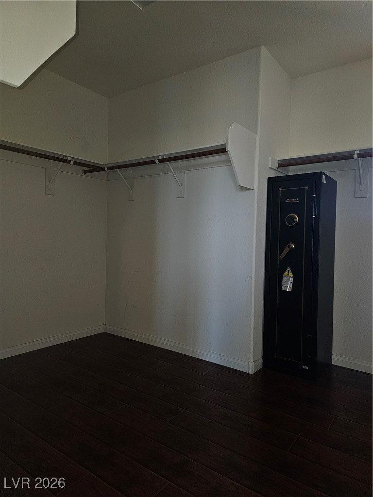 11081 Village Ridge Lane Las Vegas, NV 89135 - Photo 14 of 18 Walk in closet featuring dark wood-type flooring