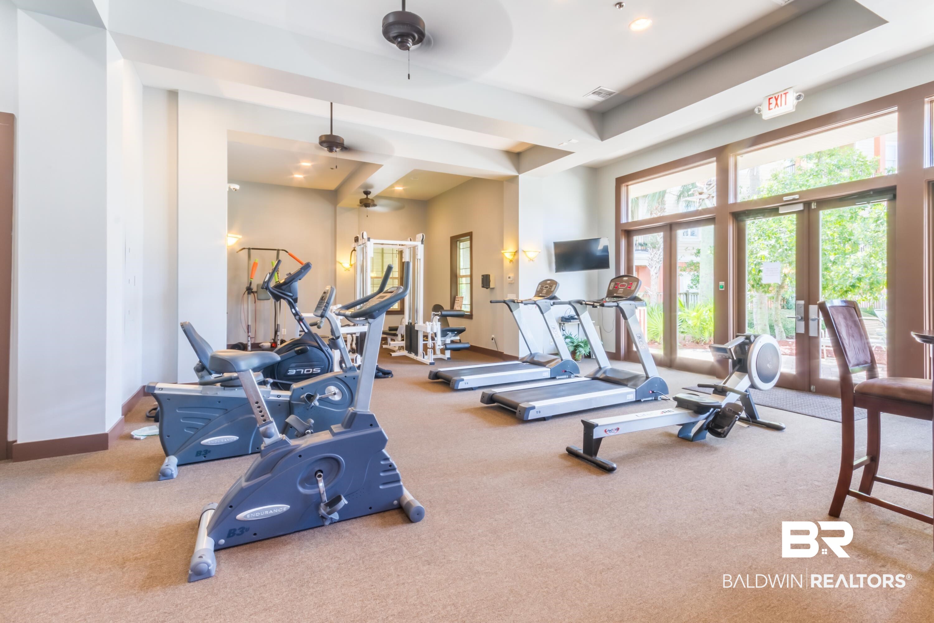 1430 Regency Road, Unit G103 Gulf Shores, AL 36542 - Photo 27 of 29 Workout area with ceiling fan, a tray ceiling, and carpet flooring