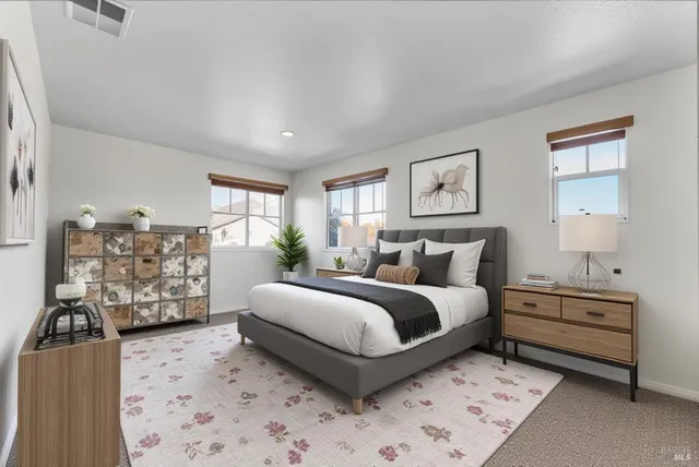 a spacious bedroom with a bed and a couch