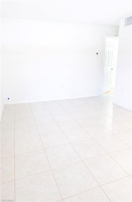3325 Airport Road North, Unit F1 Naples, FL 34105 - Photo 3 of 7 Spare room featuring light tile patterned floors and baseboards