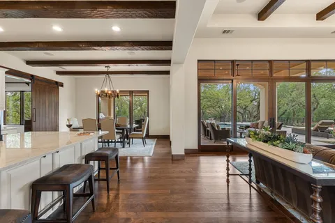 a view of kitchen and living room with wooden floor