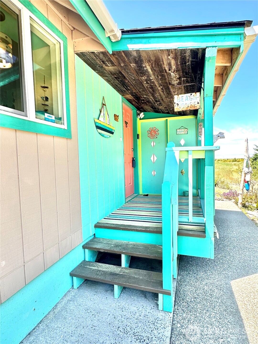 15217 Pacific Way Long Beach, WA 98631 - Photo 2 of 40 a backyard of a house with garden and outdoor seating