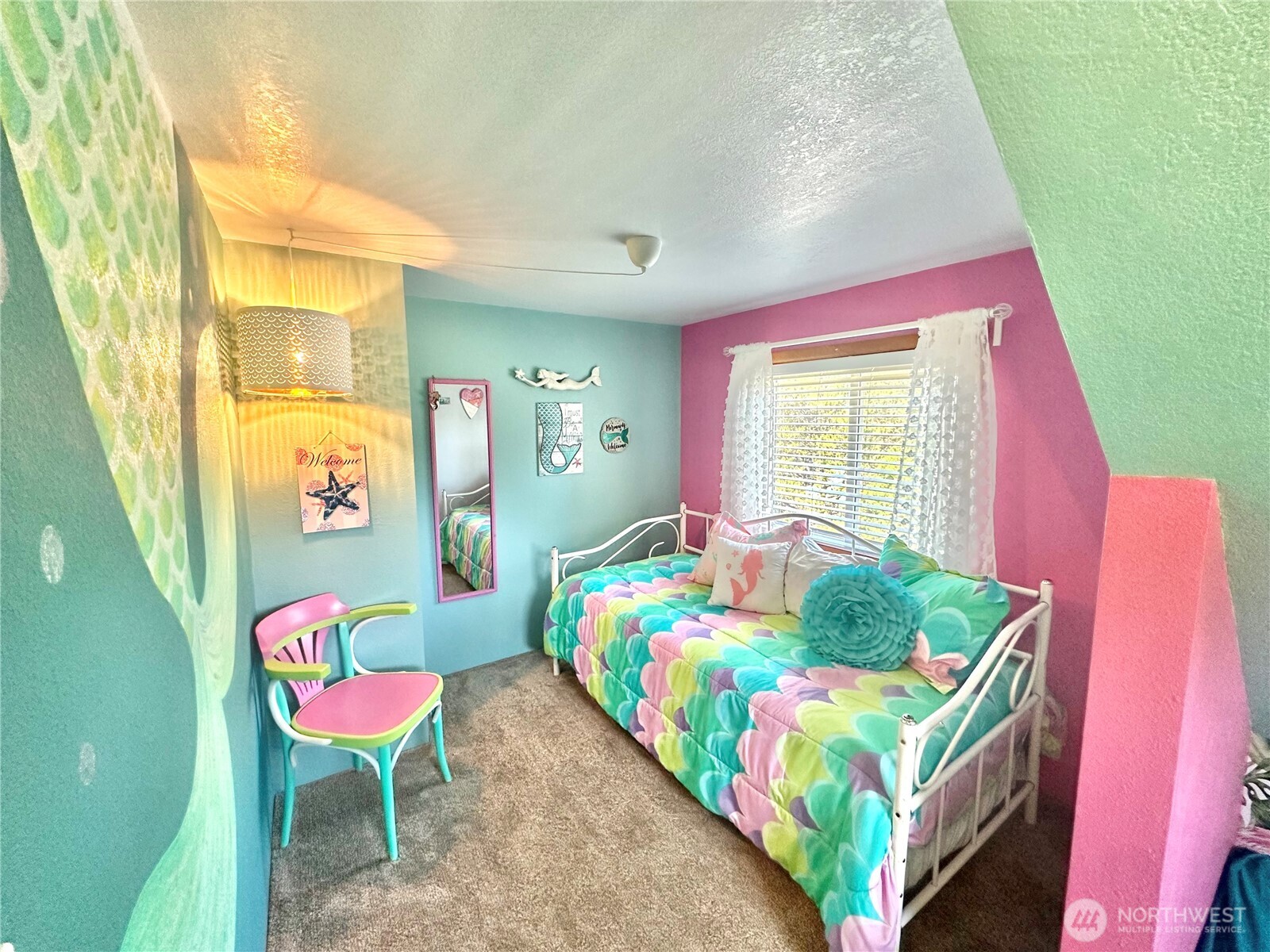 15217 Pacific Way Long Beach, WA 98631 - Photo 22 of 40 a bedroom with a bed and a chair