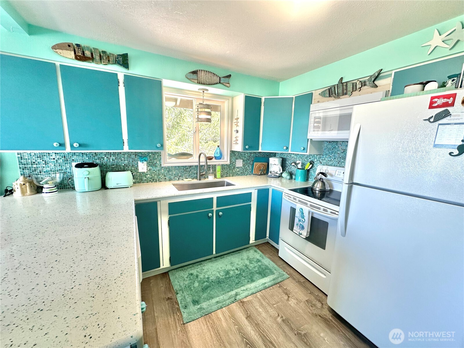 15217 Pacific Way Long Beach, WA 98631 - Photo 9 of 40 a utility room with cabinets washer and dryer