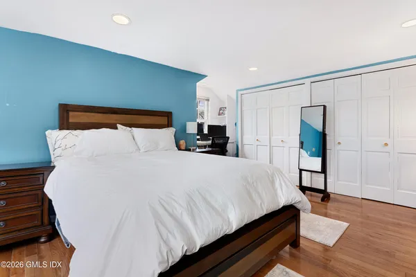 a large bed sitting in a bedroom and a table