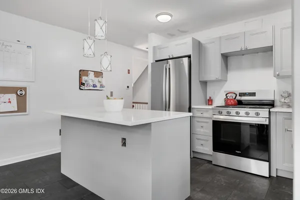 a kitchen with stainless steel appliances a stove a sink and a refrigerator