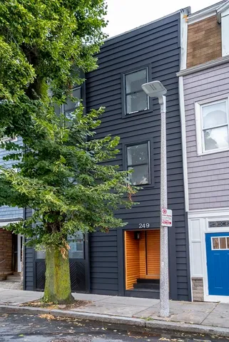 a front view of a house with trees